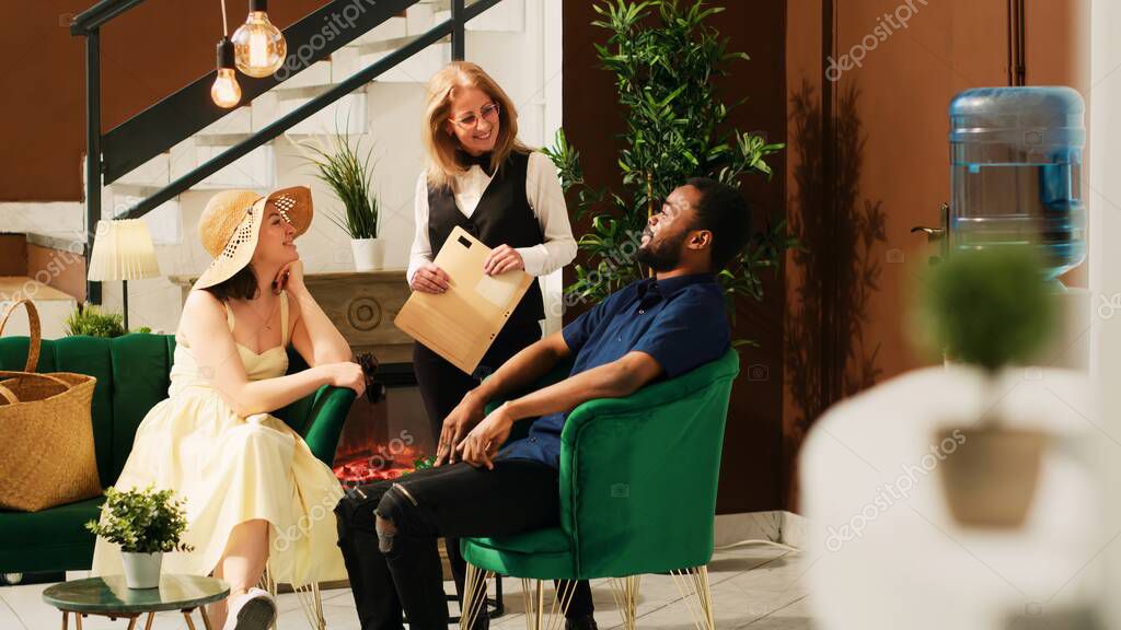 Guests checking in at a bright modern hotel lobby